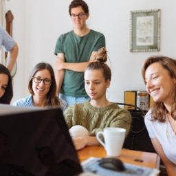 family sitting around a computer