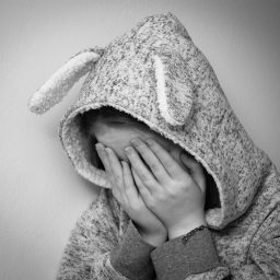 woman holding her face