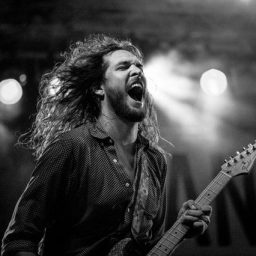 Musician playing guitar on stage