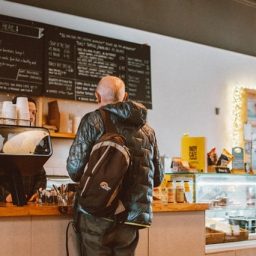 man ordering at a coffee counter