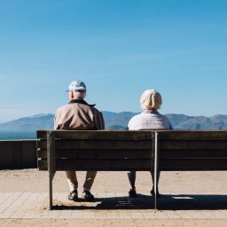 older couple sitting on a bench