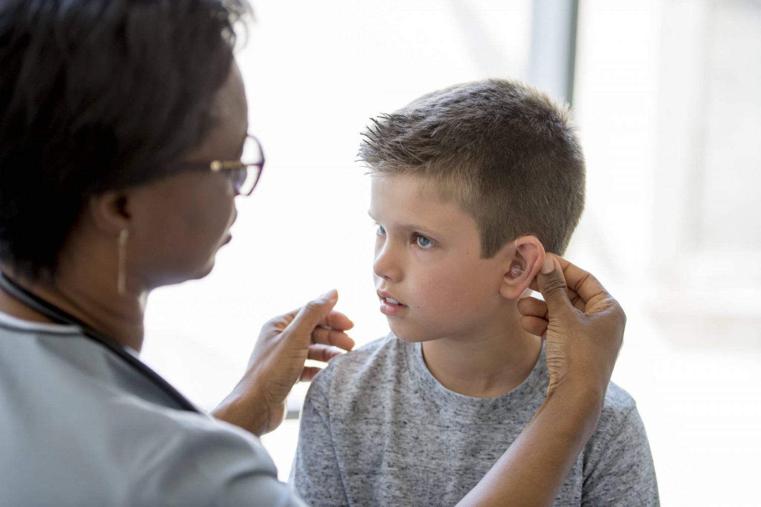 Pediatric Child Hearing Aid Fitting Child With Hearing Aid Receiving Hearing Checkup From Audiologist