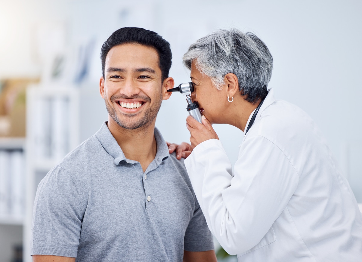 Doctor looking in her patient's ear
